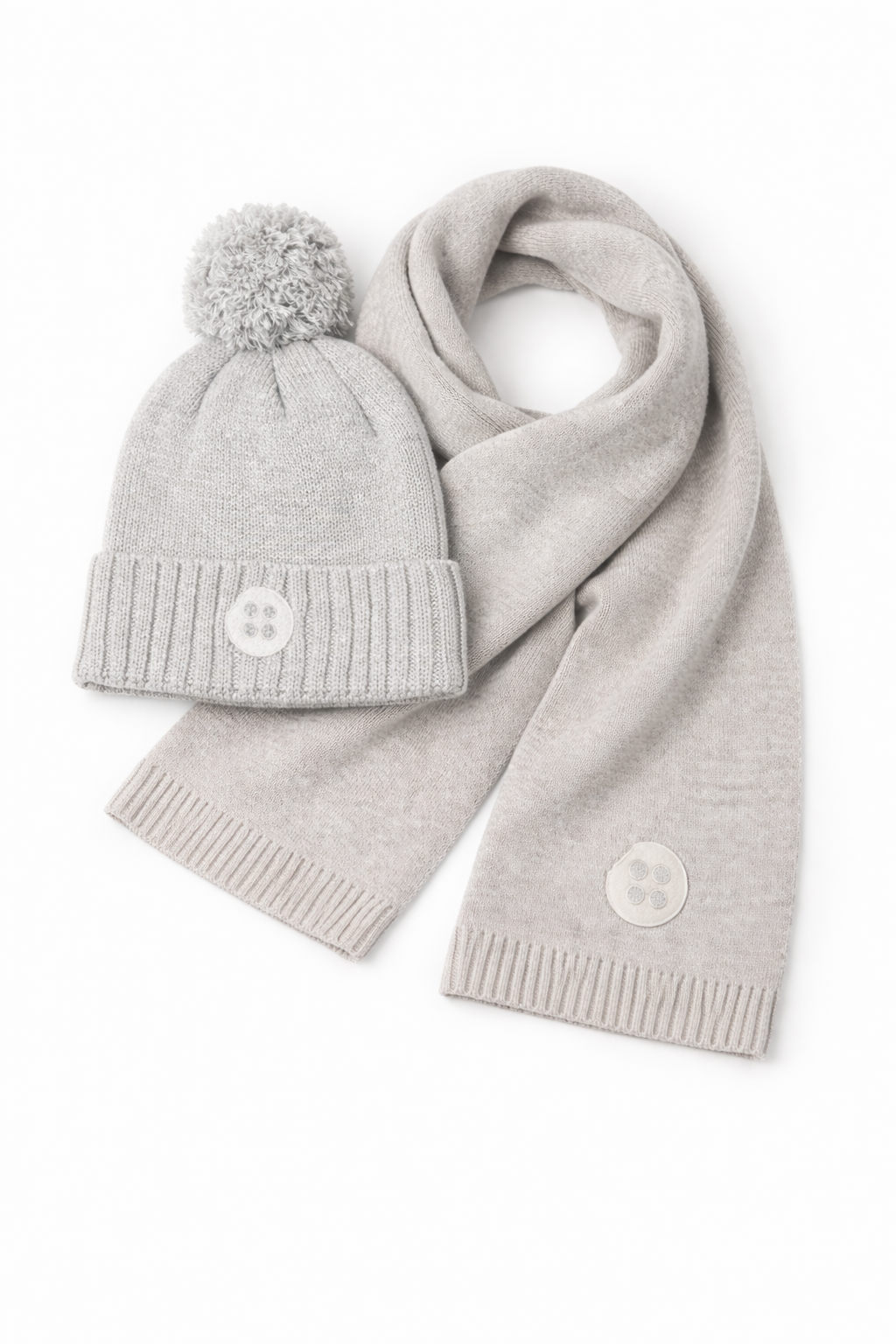 Gray knit hat with pom-pom and matching scarf on a white background